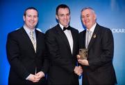 28 January 2012; Uachtarán CLG Criostóir Ó Cuana presents Oisin McCloskey, from Derry, with his Christy Ring award, alongside Alan Smullen, General Manager, Croke Park Hotel. The Christy Ring, Nicky Rackard & Lory Meagher Champion 15 Awards 2011, Croke Park, Dublin. Picture credit: Barry Cregg / SPORTSFILE