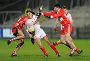 28 January 2012; Cathal McCarron, Tyrone, in action against Chrissy McKaigue and Mark Craig, Derry. Power NI Dr. McKenna Cup Final, Derry v Tyrone, Morgan Athletic Grounds, Armagh. Picture credit: Oliver McVeigh / SPORTSFILE
