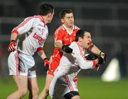 28 January 2012; Justin McMahon supported by Aidan McCrory, left, Tyrone, in action against Conleith Gilligan, Derry. Power NI Dr. McKenna Cup Final, Derry v Tyrone, Morgan Athletic Grounds, Armagh. Picture credit: Oliver McVeigh / SPORTSFILE