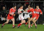 28 January 2012; Dermot Carlin, Tyrone, in action against Chrissy McKaigue and Barry McGoldrick, left, Derry. Power NI Dr. McKenna Cup Final, Derry v Tyrone, Morgan Athletic Grounds, Armagh. Picture credit: Oliver McVeigh / SPORTSFILE