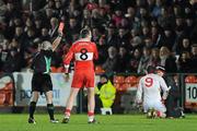 28 January 2012; James Conway, Derry, is shown a red card by referee Martin Higgins, after a first half off the ball incident, as Colm Cavanagh, Tyrone, receives attention. Power NI Dr. McKenna Cup Final, Derry v Tyrone, Morgan Athletic Grounds, Armagh. Picture credit: Oliver McVeigh / SPORTSFILE