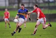 29 January 2012; Peter Acheson, Tipperary, in action against Sean Kiely, Cork. McGrath Cup Football Final, Tipperary v Cork, Clonmel Sportsfield, Clonmel, Co. Tipperary. Picture credit: Stephen McCarthy / SPORTSFILE