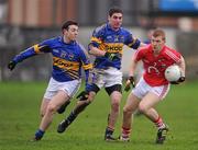 29 January 2012; Aidan O'Reilly, Cork, in action against Sean Carey, left, and Philip Austin, Tipperary. McGrath Cup Football Final, Tipperary v Cork, Clonmel Sportsfield, Clonmel, Co. Tipperary. Picture credit: Stephen McCarthy / SPORTSFILE