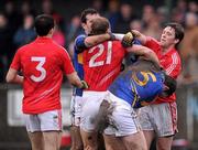 29 January 2012; Michael Shields, 21, and Sean Kiely, right, Cork, tussle with Tipperary players Seamus Grogan, left, and Barry Grogan during the game. McGrath Cup Football Final, Tipperary v Cork, Clonmel Sportsfield, Clonmel, Co. Tipperary. Picture credit: Stephen McCarthy / SPORTSFILE