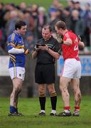 29 January 2012; Referee Padriag O'Sullivan speaks with Barry Grogan, Tipperary, and Michael Shields, Cork, before issuing both with a yellow card for an off the ball tussle. McGrath Cup Football Final, Tipperary v Cork, Clonmel Sportsfield, Clonmel, Co. Tipperary. Picture credit: Stephen McCarthy / SPORTSFILE