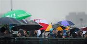 29 January 2012; Spectators shelter from the rain under their umbrellas as they watch the game. Bord na Mona Walsh Cup, University College Dublin v Galway, UCD, Belfield, Co. Dublin. Picture credit: Dáire Brennan / SPORTSFILE