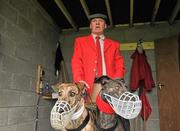 31 January 2012; Slipper Richie Quinn holds Good Morning Mam, white collar, left, and Yorkville Stella before the start of the second round of the Greyhound and Pet World Oaks. Irish National Coursing Meeting, Powerstown Park, Clonmel, Co. Tipperary. Picture credit: David Maher / SPORTSFILE