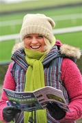 31 January 2012; Eimear Heeney, from Dundalk, Co. Louth, studies the form before the start of the second round Greyhound and Pet World Oaks. Irish National Coursing Meeting, Powerstown Park, Clonmel, Co. Tipperary. Picture credit: David Maher / SPORTSFILE