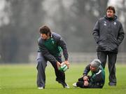 31 January 2012; Ireland's Donncha O'Callaghan looks to offload the ball, as Paddy Wallace and forwards coach Gert Smal watch on, during squad training ahead of his side's RBS Six Nations Rugby Championship game against Wales on Sunday. Ireland Rugby Squad Training, Carton House, Maynooth, Co. Kildare. Picture credit: Stephen McCarthy / SPORTSFILE