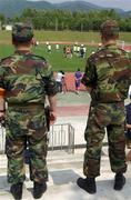 13 June 2002; Two military personnel watch on from a hillside during a Republic of Ireland training session at Sangok-dong Military Sports Facility in Seoul, South Korea. Photo by David Maher/Sportsfile