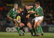 15 June 2002;  Justin Marshall of New Zealand is tackled by Ireland players, from right, Ronan O'Gara, Keith Gleeson and Simon Easterby during the Summer Tour 2002 1st Test match between New Zealand and Ireland at Carisbrook in Dunedin, Otago, New Zealand. Photo by Matt Browne/Sportsfile
