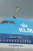 18 June 2002; KLM Flight Engineer Bert Boekel flies the Tricolour as the Republic of Ireland return home from the 2002 FIFA World Cup Finals in South Korea and Japan. Photo by Ray McManus/Sportsfile