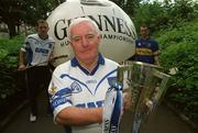 19 June 2002; Giant Among Men for 2001, Michael O'Faolain, from Dungarvan, Co. Waterford, pictured earlier today, alongside Hurling giants Ken McGrath of Waterford, left, and Thomas Dunne of Tipperary, right, to launch the nationwide 2002 Guinness &quot;Giant Among Fans&quot; promotion. Michael faught off stiff competition from hurling supporters from other counties when he was crowned Ireland's number 1 hurling supporter last year in the Guinness Storehouse the night before the All-Ireland Hurling Final. Photo by Brendan Moran/Sportsfile