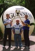 19 June 2002; Hurling giants Ken McGrath, Waterford, left, and Thomas Dunne, Tipperary, right, with Michael O'Faoláin, from Dungarvan, Co. Waterford, pictured earlier today to launch the nationwide 2002 Guinness &quot;Giant Among Fans&quot; promotion. Michael faught off stiff competition from hurling supporters from other counties when he was crowned Ireland's number 1 hurling supporter last year in the Guinness Storehouse the night before the All-Ireland Hurling Final. Photo by Brendan Moran/Sportsfile