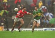 16 June 2002; Eamon Fitzmaurice of Kerry in action against Martin Cronin of Cork during the Bank of Ireland Munster Senior Football Championship Semi-Final match between Kerry and Cork at Fitzgerald Stadium in Killarney, Kerry. Photo by Brendan Moran/Sportsfile
