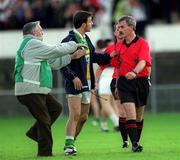 22 June 2002; Roy Malone of Offaly is restrained by a steward while remonstrating with referee Paddy Russell following the Bank of Ireland Leinster Senior Football Championship Semi-Final Replay match between Kildare and Offaly at Nowlan Park in Kilkenny. Photo by Damien Eagers/Sportsfile
