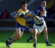 22 June 2002; Michael O'Dwyer of Clare is tackled by David Brennan of Laois during the Bank of Ireland All-Ireland Senior Football Championship Qualifying Round 2 match between Laois and Clare at O'Moore Park in Portlaoise, Laois. Photo by Aoife Rice/Sportsfile