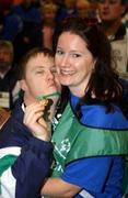 23 June 2002; Special Olympian Grant Wilson embraces Volunteer Siobhan Hennessy during the 2002 Special Olympics Ireland National Games closing ceremony at the RDS in Dublin. Photo by Ray McManus/Sportsfile