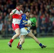 23 June 2002; Shane Carroll of Longford is tackled by Derry's Patrick Bradley during the Bank of Ireland All-Ireland Senior Football Championship Qualifier Round 2 match between Longford and Derry at Pearse Park in Longford. Photo by Aoife Rice/Sportsfile