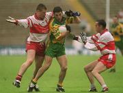 16 June 2002; Michael Hegarty of Donegal in action against Niall McCusker, left, and Gary Coleman of Derry during the Bank of Ireland  Ulster Senior Football Championship Semi-Final match between Donegal and Derry at St TiernachÕs Park in Clones, Monaghan. Photo by Damien Eagers/Sportsfile