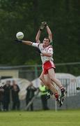 29 June 2002; Jarlath Quinn of Tyrone in action against Leitrim's Gary McCloskey during the Bank of Ireland All-Ireland Senior Football Championship Qualifying Round 2 match between Tyrone and Leitrim at Páirc Seán Mac Diarmada in Carrick-on-Shannon, Leitrim. Photo by Aoife Rice/Sportsfile