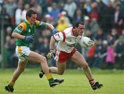 29 June 2002; Brian Dooher of Tyrone is tackled by Leitrim's Shane Foley during the Bank of Ireland All-Ireland Senior Football Championship Qualifying Round 2 match between Tyrone and Leitrim at Páirc Seán Mac Diarmada in Carrick-on-Shannon, Leitrim. Photo by Aoife Rice/Sportsfile