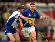 30 June 2002; John Carroll of Tipperary, in action against Waterford's Tom Feeney during the Guinness Munster Senior Hurling Championship Final match between Waterford and Tipperary at Páirc Uí Chaoimh in Cork. Photo by Brendan Moran/Sportsfile