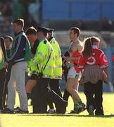 29 June 2002; Referee Barry Kelly is escorted from the pitch by Gardai following the Guinness All-Ireland Senior Hurling Championship Qualifying Round 1 match between Cork and Limerick at Semple Stadium in Thurles, Tipperary. Photo by Brendan Moran/Sportsfile