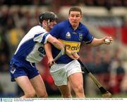 30 June 2002; John Carroll, Tipperary, in action against Waterford's Tom Feeney. Waterford v Tipperary, Guinness Munster Hurling Final, Pairc Ui Chaoimh, Cork. Picture credit; Brendan Moran / SPORTSFILE