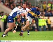 30 June 2002; Eoin Kelly, Tipperary, in action against Waterford's Fergal Hartley. Waterford v Tipperary, Guinness Munster Hurling Final, Pairc Ui Chaoimh, Cork. Picture credit; Brendan Moran / SPORTSFILE