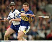30 June 2002; John Carroll , Tipperary, in action against Waterford's  Tom Feeney  . Waterford v Tipperary, Guinness Munster Hurling Final, Pairc Ui Chaoimh, Cork. Picture credit; Brendan Moran / SPORTSFILE
