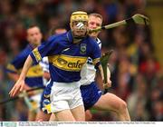 30 June 2002; Lar Corbett, Tipperary, in action against Waterford's Brian Flannery. Waterford v Tipperary, Guinness Munster Hurling Final, Pairc Ui Chaoimh, Cork. Picture credit; Brendan Moran / SPORTSFILE