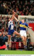 30 June 2002; Brian O'Meara , Tipperary, in action against Waterford's Peter Queally. Waterford v Tipperary, Guinness Munster Hurling Final, Pairc Ui Chaoimh, Cork. Picture credit; Brendan Moran / SPORTSFILE