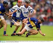 30 June 2002; Thomas Dunne , Tipperary, in action against Waterford's Dave Bennett . Waterford v Tipperary, Guinness Munster Hurling Final, Pairc Ui Chaoimh, Cork. Picture credit; Brendan Moran / SPORTSFILE