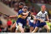 30 June 2002; Thomas Costello, Tipperary, is tackled by Waterford's Seamus Prendergast. Guinness Munster Hurling Final, Waterford v Tipperary, Pairc Ui Chaoimh, Cork.  Picture credit; Brendan Moran / SPORTSFILE