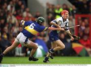 30 June 2002; Waterford's John Mullane is tackled by David Kennedy. Guinness Munster Hurling Final, Waterford v Tipperary, Pairc Ui Chaoimh, Cork.  Picture credit; Brendan Moran / SPORTSFILE