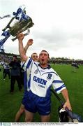30 June 2002; Waterford's Brian Greene celebrates with the cup after defeating Tipperary. Waterford v Tipperary, Guinness Munster Hurling Final, Pairc Ui Chaoimh, Cork. Picture credit; Brendan Moran / SPORTSFILE