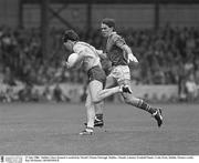 27 July 1986;  Dublin's Dave Synnott is tackled by Meath's Finian Murtagh. Dublin v Meath, Leinster Football Finals, Croke Park, Dublin. Picture credit; Ray McManus / SPORTSFILE
