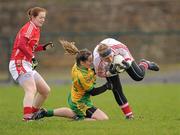 5 February 2012; Elaine Harte and Ann Marie Walsh, left, Cork, in action against Geraldine McLoughlin, Donegal. Bord Gais Energy Ladies National Football League, Division 1, Round 1, Donegal v Cork, Fr. Tierney Park, Ballyshannon, Donegal. Photo by Sportsfile