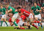 5 February 2012; Jamie Heaslip, Ireland, is tackled by Ian Evans, left, and Toby Faletau, Wales. RBS Six Nations Rugby Championship, Ireland v Wales, Aviva Stadium, Lansdowne Road, Dublin. Picture credit: Stephen McCarthy / SPORTSFILE