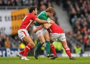 5 February 2012; Andrew Trimble, Ireland, is tackled by Mike Phillips, left, and Rhys Gill, Wales. RBS Six Nations Rugby Championship, Ireland v Wales, Aviva Stadium, Lansdowne Road, Dublin. Picture credit: Stephen McCarthy / SPORTSFILE