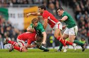 5 February 2012; Andrew Trimble, Ireland, with support from team mate Cian Healy, is tackled by Mike Phillips, left, and Rhys Gill, Wales. RBS Six Nations Rugby Championship, Ireland v Wales, Aviva Stadium, Lansdowne Road, Dublin. Picture credit: Stephen McCarthy / SPORTSFILE