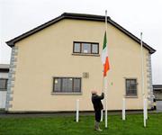 5 February 2012; Paddy Butler, pitch co-ordinator at the St Lachtin's GAA CLub, lowers the Tricolour after the days proceedings. Allianz Football League, Division 4, Round 1, Kilkenny v Wicklow, Freshford GAA Grounds, Freshford, Co. Kilkenny. Picture credit: Ray McManus / SPORTSFILE