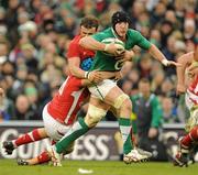 5 February 2012; Stephen Ferris, Ireland, is tackled by Justin Tipuric and Jamie Roberts, Wales. RBS Six Nations Rugby Championship, Ireland v Wales, Aviva Stadium, Lansdowne Road, Dublin. Picture credit: Brendan Moran / SPORTSFILE