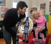 8 February 2012; RBS 6 Nations and Triple Crown Trophies arrive in Dublin: Leinster rugby stalwart Shane Horgan is pictured with Holly Clarke, aged 1, from Kilbarrack, Dublin, her mother Carmel, and the Triple Crown. Bernard Jackman and Shane Horgan brought the prestigious trophies to the Ulster Bank Donnybrook branch to share with staff and customers as part of the bank’s RBS 6 Nations Trophy Tour which aims to highlight the Ulster Bank RugbyForce club initiative, where clubs can register by April 13th on www.ulsterbank.com/rugby for the chance to win a club makeover worth €5,000. The pair then travelled to Temple Street Children’s Hospital to share the trophies with the children. Temple Street Children's University Hospital, Dublin. Picture credit: Pat Murphy / SPORTSFILE