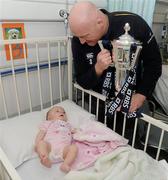 8 February 2012; RBS 6 Nations and Triple Crown Trophies arrive in Dublin: Leinster rugby stalwart Bernard Jackman is pictured with Ava Donnelly, aged 3 months, from Dublin, and the RBS 6 Nations Trophy. Bernard Jackman and Shane Horgan brought the prestigious trophies to the Ulster Bank Donnybrook branch to share with staff and customers as part of the bank’s RBS 6 Nations Trophy Tour which aims to highlight the Ulster Bank RugbyForce club initiative, where clubs can register by April 13th on www.ulsterbank.com/rugby for the chance to win a club makeover worth €5,000. The pair then travelled to Temple Street Children’s Hospital to share the trophies with the children. Temple Street Children's University Hospital, Dublin. Picture credit: Pat Murphy / SPORTSFILE