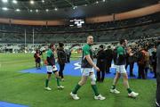 11 February 2012; The Ireland team, including Ronan O'Gara, captain Paul O'Connell and Peter O'Mahony leave the pitch after going through a warm-down routine as supporters leave the stadium after the game was called off. RBS Six Nations Rugby Championship, France v Ireland, Stade de France, Paris, France. Picture credit: Brendan Moran / SPORTSFILE