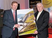 14 February 2012; Photographer John Cleary, from Tralee, Co. Kerry, presenting An Taoiseach Enda Kenny TD with one of his photographs at the launch of the Tayto Longford Arms Comótas Peile Páidi O’Sé 2012. The invitational GAA tournament, which will take place from 24-26 February 2012 across the Dingle Peninsula, will see 26 senior, intermediate and junior GAA club teams competing from 15 counties and greater London area. This year, the men's senior cup will be renamed in memory of former Defence Forces Chief of Staff Dermot Earley. For full details check out www.paidiose.com. Launch of the Tayto Longford Arms Comótas Peile Páidi O’Sé 2012, D4 Berkeley Hotel, Dublin. Photo by Sportsfile