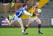 29 January 2012; James Holmes, Wexford, in action against Conor Boyle, Laois. Bord Na Mona O'Byrne Shield Final, Wexford v Laois, Wexford Park, Wexford. Picture credit: Matt Browne / SPORTSFILE