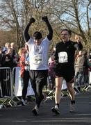 18 February 2012; Killian Byrne, Rathfarnham, Dublin, of the Operation Transformation leaders team crosses the finish line with Dr. Eddie Murphy, right, during the Operation Transformation Race 2012. Phoenix Park, Dublin. Picture credit: Pat Murphy / SPORTSFILE